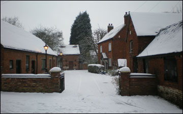 Winters sceen with snow coverd roofs of Church Farm  otherwise 