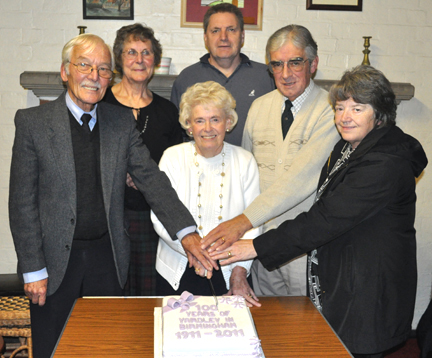 The Committee are photographed cutting the cake