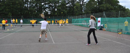 Hana Handlikova and Ashcon Rezazadeh play tennis with the Children